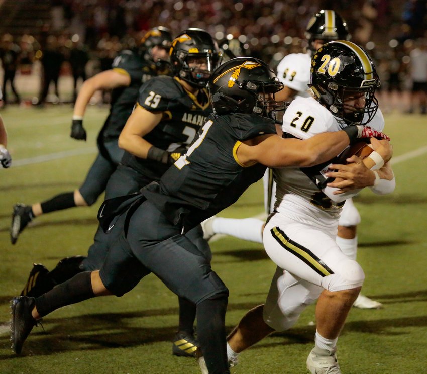 Rock Canyon's Aidan Duda rumbles down the field as Arapahoe's Chase Hancock tries to make the tackle during the teams' Sept. 23 game in Littleton.